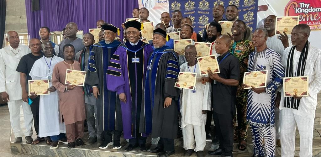 IFM apostolic leaders in academic regalia presenting credentials to ministers at a ceremony
